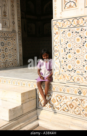 Junges Mädchen saß am Eingang zum I'timad-Ud-Daulah "Baby Taj" am Ufer des Flusses Yamuna in Agra, Indien Stockfoto