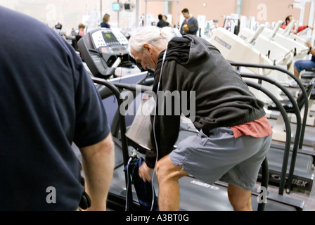 Älterer Mann mit Hilfe einer Sauerstoffmaske wegen seine Lungenkrankheit bei einem lokalen Fitnessstudio ausüben kann. Stockfoto