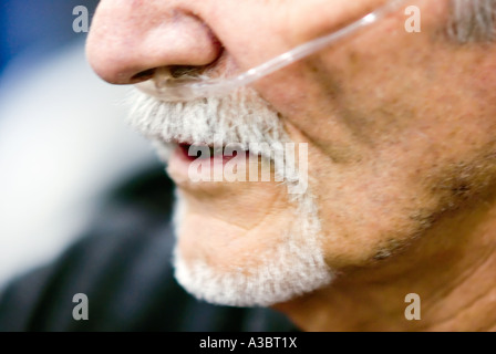 Älterer Mann mit Hilfe einer Sauerstoffmaske wegen seine Lungenkrankheit bei einem lokalen Fitnessstudio ausüben kann. Stockfoto