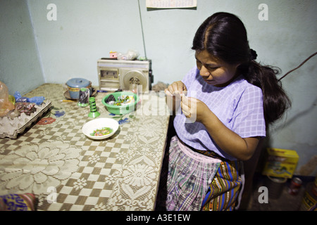 GUATEMALA SAN PEDRO LA LAGUNA Young Tzutujil indigenen Maya-Frau in traditioneller Kleidung als Haushälterin beschäftigt Stockfoto