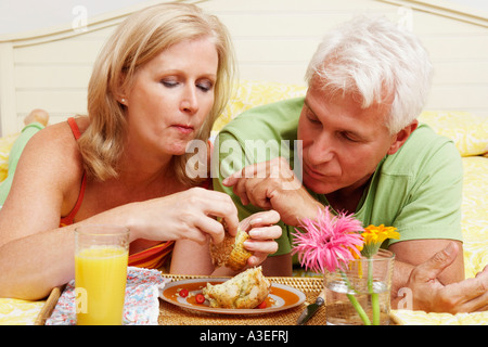 Ein älteres Paar im Bett frühstücken in Nahaufnahme Stockfoto