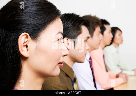 Drei Unternehmer und zwei Unternehmerinnen sitzen nebeneinander Stockfoto