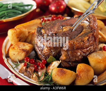 Eine ganze Roastbeef mit Bratkartoffeln in einen festlich gedeckten Tisch setzen redaktionelle Essen Stockfoto