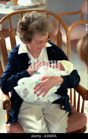 Urgroßmutter Alter von 85 Jahren Betrieb Neugeborenen Enkel nach der Geburt. Edina, Minnesota USA Stockfoto