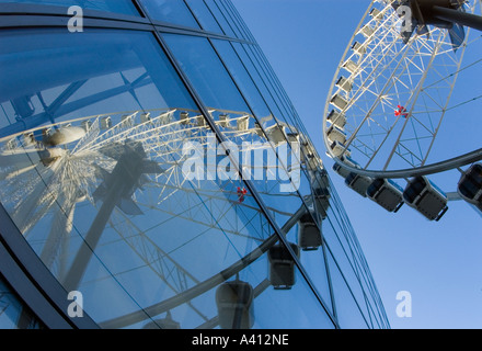 Verzerrtes Spiegelbild der Manchester Wheel in die Glasfenster von Selfridges speichern Januar 2006 vor einem strahlend blauen Himmel Stockfoto