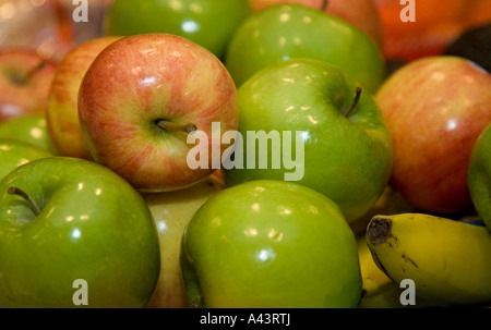 Grüne Äpfel und Bananen in eine Schüssel geben Stockfoto