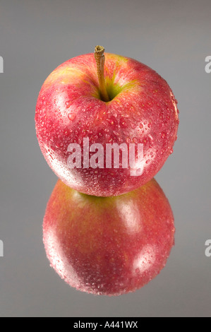 Roter Apfel in Tröpfchen reflektiert Spiegelkarte abgedeckt Stockfoto