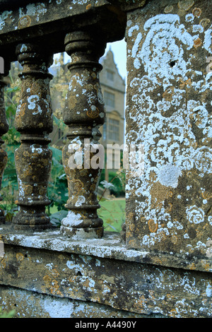 Nahaufnahme von Flechten bedeckt alten Steinmauer mit Blick durch Geländer Stockfoto