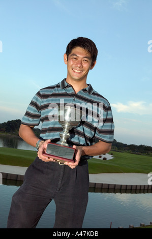 Asiatischer Mann hält eine Trophäe Stockfoto