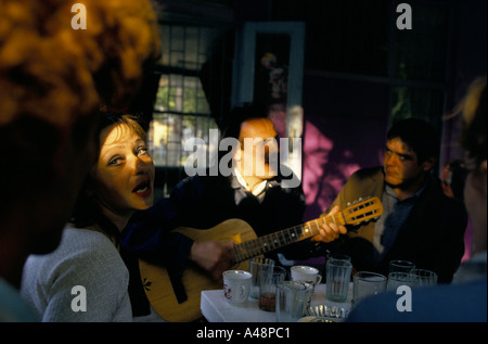 Frau singt zusammen mit Mann spielt Gitarre, sitzen in einem Café in Simferopol Krim ukraine Stockfoto
