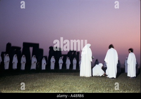 Eine Gruppe von Druiden feiern die aufgehende Sonne während der Sommersonnenwende in Stonehenge Stockfoto