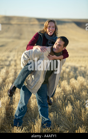 Auf lachende Frau mans wieder in Grasschnitt Felder im Herbst Colorado Stockfoto