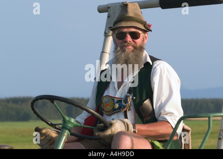 traditionelle bekleidet Bauer mit Weste und Tiroler Hut auf einem Traktor Dietramszell Bayern Deutschland Herr Nr. 0017 Stockfoto