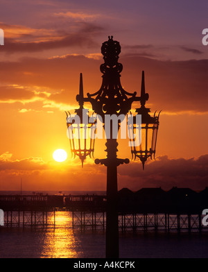 Alte verzierte Straßenlaterne, Madeira Drive, Brighton. Hintergrund: das Palace Pier. Stockfoto