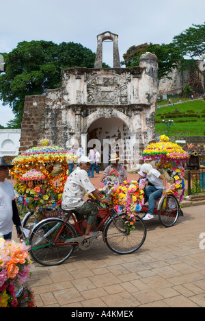 Bunt geschmückten Fahrradrikschas außerhalb der ein Famosa portugiesische Fort in Malacca Stockfoto