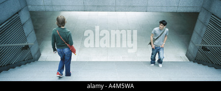 Junge Menschen, die einander auf Treppe vorbei Stockfoto