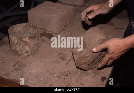 Colin Richards die Ziegel von hand funktioniert des Tons vor dem setzen es in die Form Stockfoto