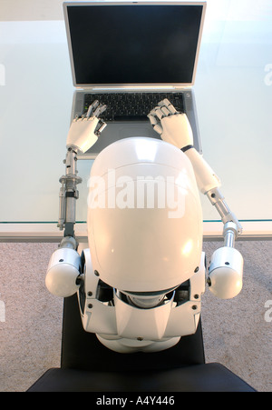 Weibliche humanoide Roboter, die einen Laptop-Computer in Betrieb Stockfoto