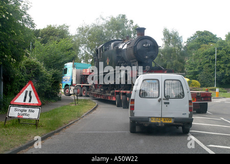 Dampflokomotive, die auf der Straße auf der Rückseite eines LKW transportiert werden Stockfoto