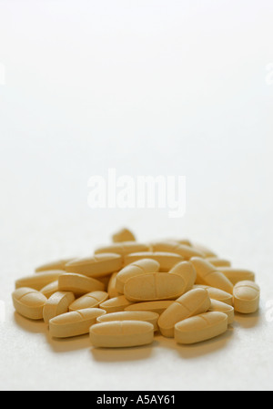 Helle gelbe Generika Tabletten in einem Stapel auf weißem Hintergrund Stockfoto