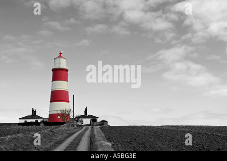 Traditionelle rot-weiß der Leuchtturm der britisches Englisch bei Happisburgh mit selektiv farbigen schwarz weißen urbaren Ackerland UK Stockfoto