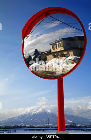 Japanisches Haus in einer Straße Spiegel mit Mount Iwaki, Aomori im Hintergrund Stockfoto