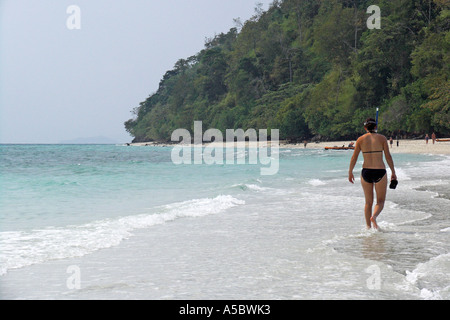 Frau im Bikini geht bei Ebbe auf den aufstrebenden Sandbank zwischen Ko Tup und Ko Kai oder Gai in der Nähe von Krabi Thailand Stockfoto