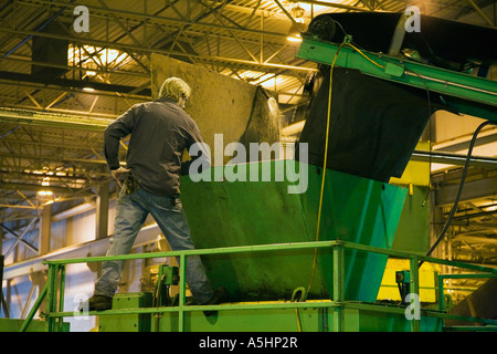 Wyandotte, Michigan A Arbeiter Uhren eine Maschine Schreddern Reifen bei Silver Lining Reifen-Recycling Stockfoto