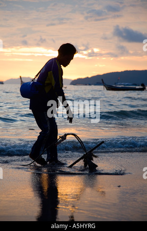 Boatman Anheben der Anker der longtailed Boot Railey Beach Lagoon, Provinz Krabi Thailand Stockfoto