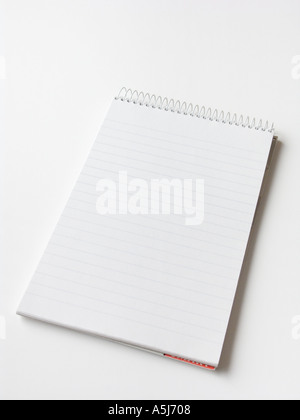 A spiral bound notepad on a plain white background Stockfoto