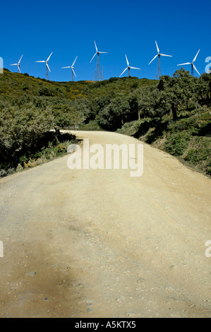 Windkraftanlagen auf Hügel über unbefestigte Straße, Tarifa, Andalusien, Spanien. Stockfoto