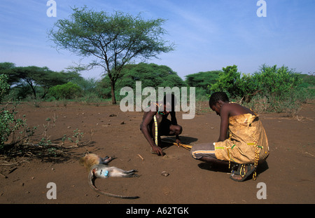 Hadza Jäger macht ein Feuer zum Grillen eines Affe Lake Eyasi Tansania kleine Stammes der Jäger und Sammler Stockfoto