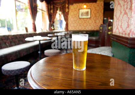 Glas Bier saß am Tisch in der leeren Bar im Laufe des Tages Stockfoto