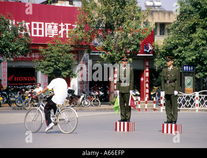 Zwei Polizisten in steife Haltung an einer Kreuzung stehen, warten auf hohe Politiker, vorbei. Jianshui, China. Stockfoto