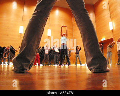 Teenager Schüler unter einer Klasse im afrikanischen Tanz gesehen durch die Beine eines teilnehmenden Studenten Stockfoto