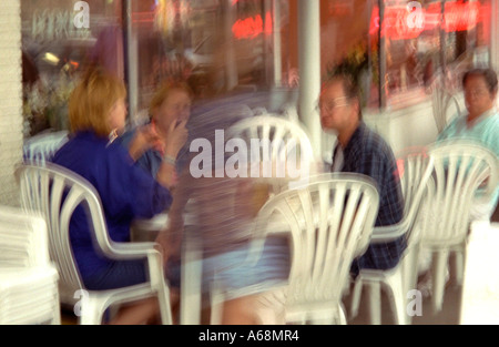 Verschwommene Menschen Alter 25 wartet der Aquatennial-Fackelzug in Outdoor-Straßencafé. Minneapolis Minnesota USA Stockfoto