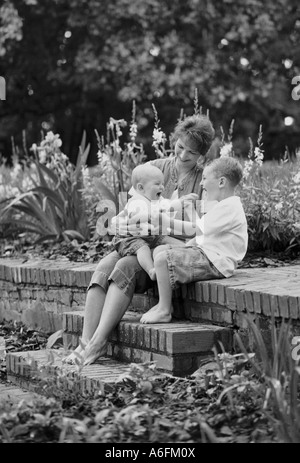 Mutter und Kinder im Garten Stockfoto