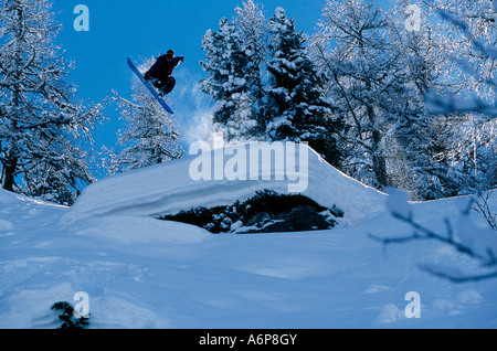 Snowboarder in der Lage sein Grab herüber Ar steile verschneiten Grat abseits der piste Stockfoto