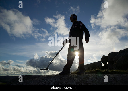 Mann mit Metalldetektor Silhouette gegen trübe & blauen Himmel. Stockfoto