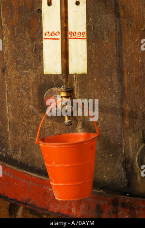 Kinder Spielzeug Eimer Wein Tropfen zu vermeiden. Chateau de Nouvelles. Fitou. Languedoc. Fasskeller. Hölzerne Gär- und Lagertanks. Tank-Auslauf. Frankreich. Europa. Stockfoto