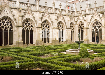 Gotischer Pandhof und kleiner Garten der Domkirche in Utrecht, Holland, mit komplizierten Steinbögen und gepflegten Buchsbaumhecken. Stockfoto
