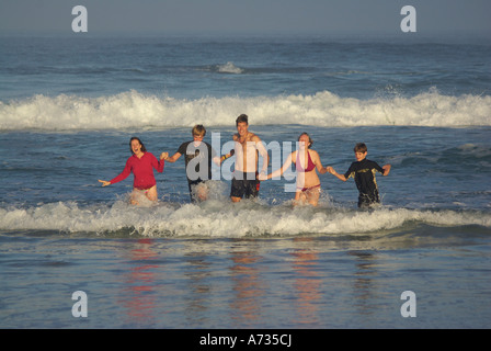 Familie, die aus dem Meer Hand in Hand Stockfoto