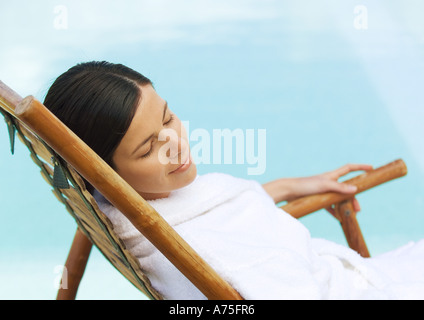 Frau im Liegestuhl, Bademantel tragen Stockfoto