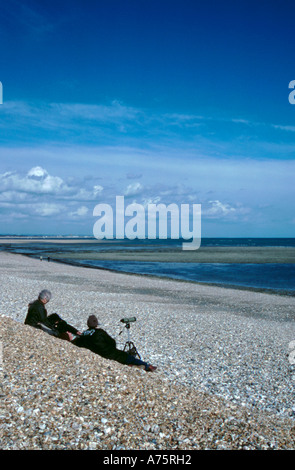 Vogelbeobachter auf einem Kiesstrand; Pagham, in der Nähe von Selsey Bill, West Sussex, England, UK. Stockfoto