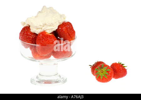 Fresh strawberries and a blob of thick cream in glass bowl on a pure white background. Stockfoto
