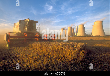 Ein Mähdrescher ernten eine Weizenernte mit Ratcliffe auf sauer Kohle abgefeuert Kraftwerk hinter. Stockfoto