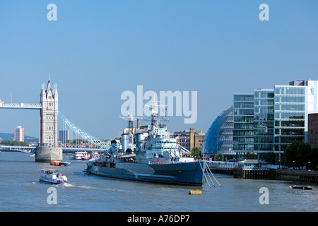 Ein Blick auf die Themse mit Rathaus, Tower Bridge, HMS Belfast und einem Ausflugsschiff vor blauem Himmel. Stockfoto