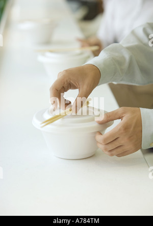 Mann, Abholung Stäbchen essen zum Mitnehmen Container, beschnitten, Ansicht Stockfoto