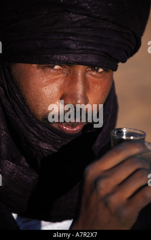 Libyen, Region der Wüste, Fezzan (Sahara), ein Tuareg in traditioneller Tracht trinken Pfefferminztee Stockfoto