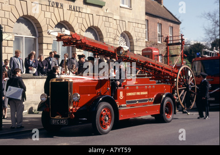 Glastonbury Hochzeitsgäste auf und um restaurierte altmodische Feuerwehrmaschine im Begriff, weg von Town Hall Somerset England Großbritannien zu bewegen Stockfoto